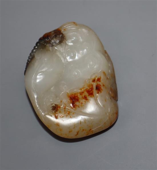 A Chinese white and russet jade carving of a lotus pod